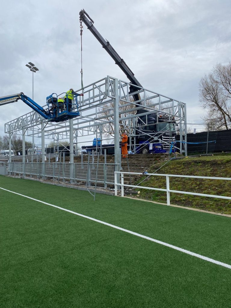 Workers are assembling a metal structure