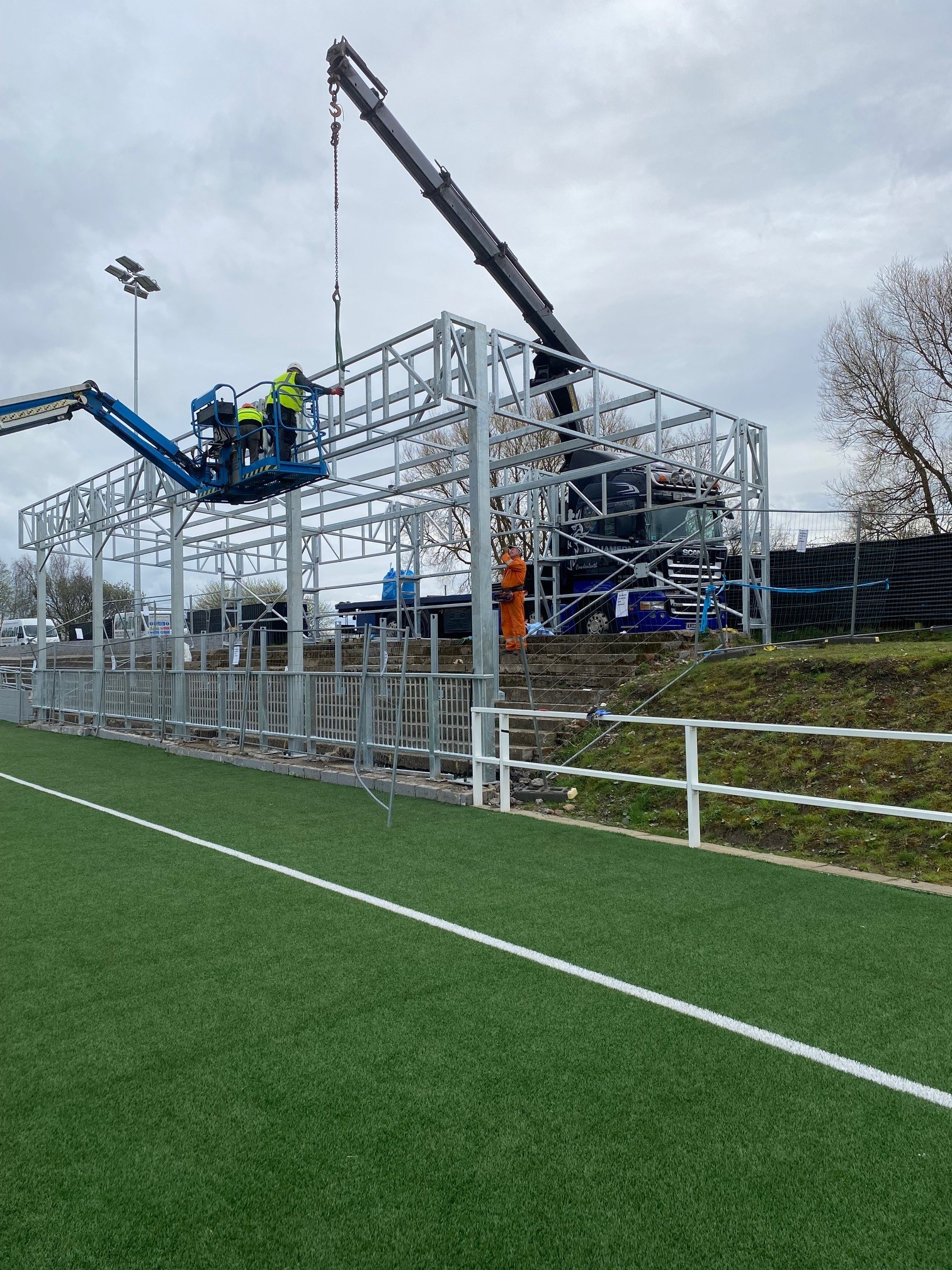Workers are assembling a metal structure 